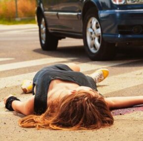 Dead woman lying on a street