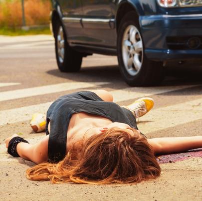 Dead woman lying on a street
