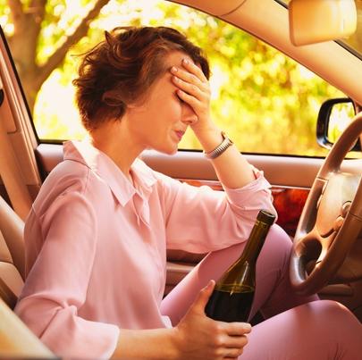 Woman Drinking Alcohol in Car