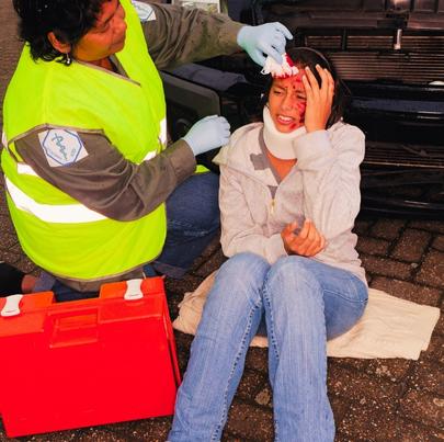 Female paramedic attending to woman car crash victim