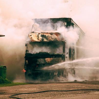 Fire and smoke on the road after a truck collision