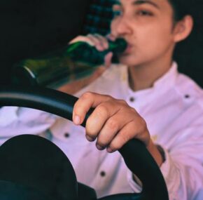 Woman is drinking while driving