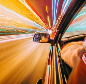 View from the side of a car, going on the road, blurred motion. focus on mirror.