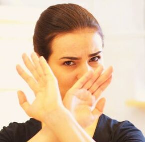 Woman in "denied" hand gesture