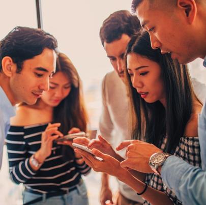 Group of millennials checking posts in social media