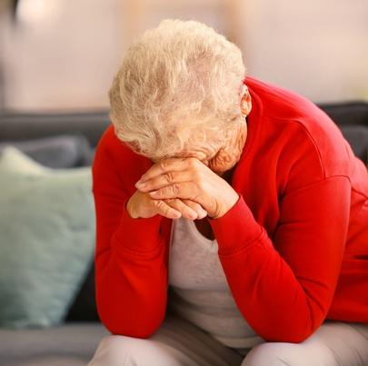 Sad, depressed, emotionally abused elderly woman at a nursing home