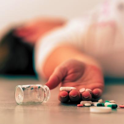 Dead woman on the floor after overdosing on prescription drugs