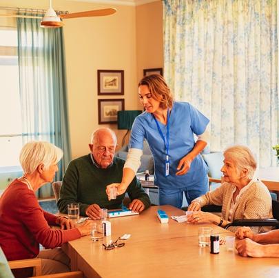 Nurse Giving Daily Medicine to Seniors at Nursing Home
