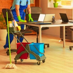 Male Housekeeper Cleaning in Office