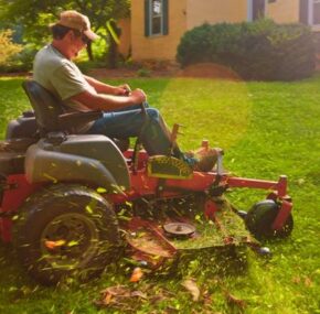 Landscaper cutting grass riding his lawn mower