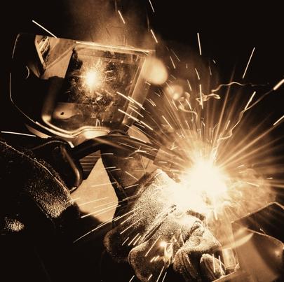 Arc flash while welder is working on a metal sheet
