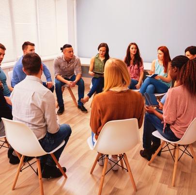 Group of people sitting in circle during counseling