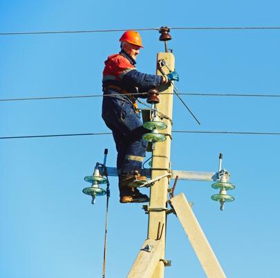 Power Electrician Lineman at Work on Pole