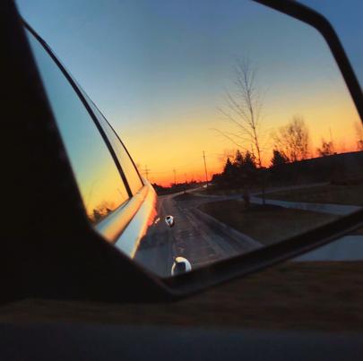 Sunset in car mirror. Late night drive during spring break