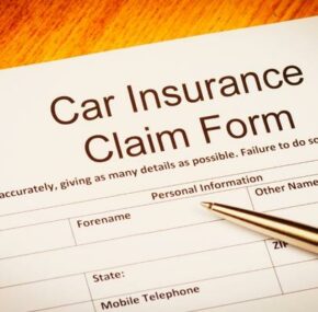Car insurance claim form on the desk with ballpoint pen