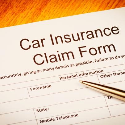 Car insurance claim form on the desk with ballpoint pen