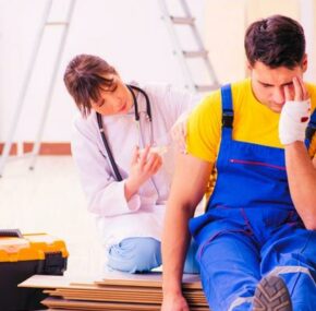 Injured worker being assisted by a female doctor