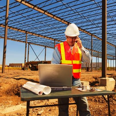 Construction worker using modern technology in construction site