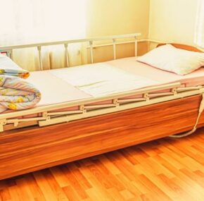 Nursing home bed with bed rails for elderly patient