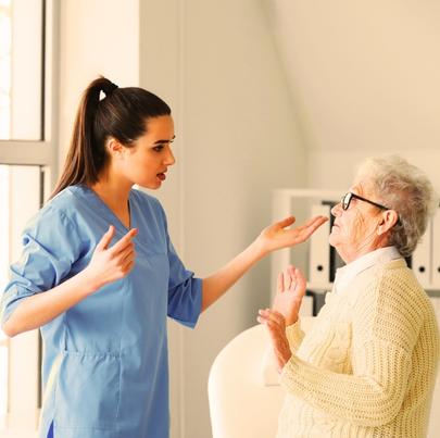 Female worker mistreating senior woman in nursing home