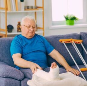 Senior man with broken legs at a nursing home