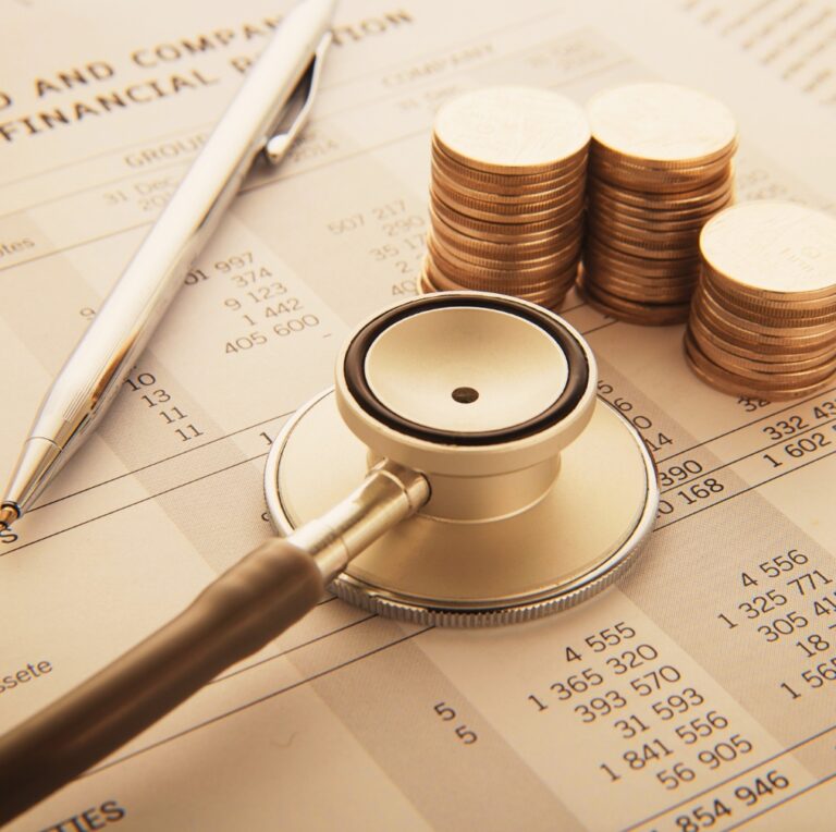 Pen and stethoscope on top of the unpaid medical bill