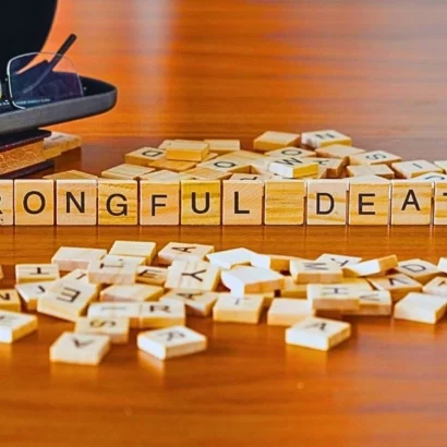 Wrongful death word or concept represented by wooden letter tiles on a wooden table.