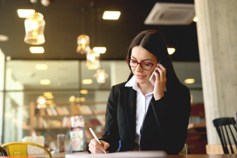 Lawyer sitting at a desk taking notes.
